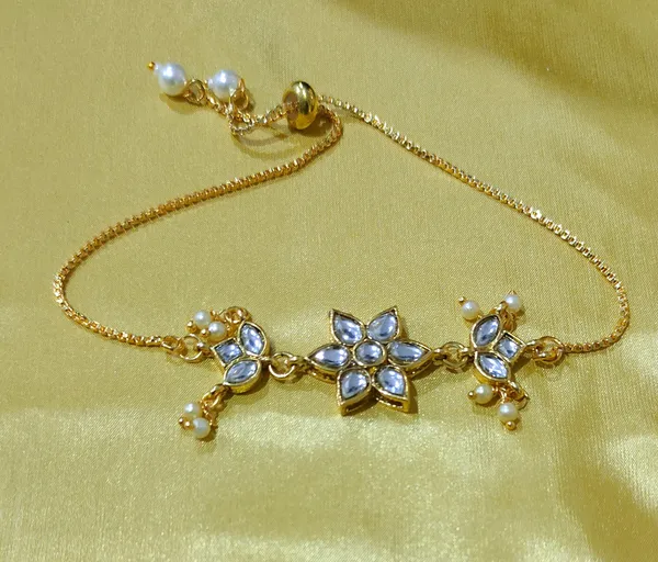 Elegant_Gold-Toned_Starburst_Bracelet_with_Crystal_Accents_and_Delicate_Pearl_Drops