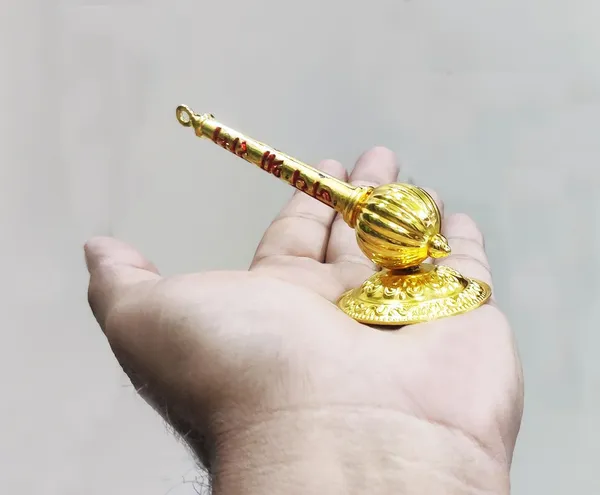 Golden_Metal_Made_Bajrang_Bali_Small_Gada_With_Stand_For_Keeping_In_Home_Temple/Car_Dashboard_Or_Gifting_To_Hanuman_Ji_Size-_4_Inch_Wt-100_Gram_Approx