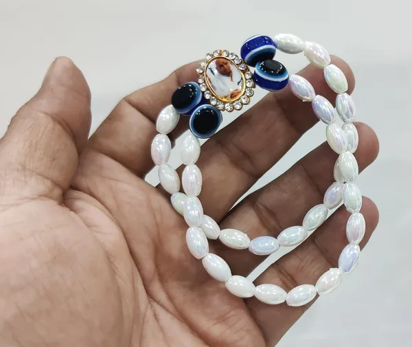 White_Piece_Jai_Guru_Ji_Swaroop_White_Pearl_Bracelet_With_A_Metallic_Finger_Ring_For_Ladies_Gift_For_Devotees_(2_Items)