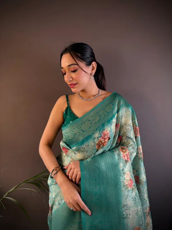 Teal_Or_Sea_Green_Floral_Organza_Saree_With_Zari_Border