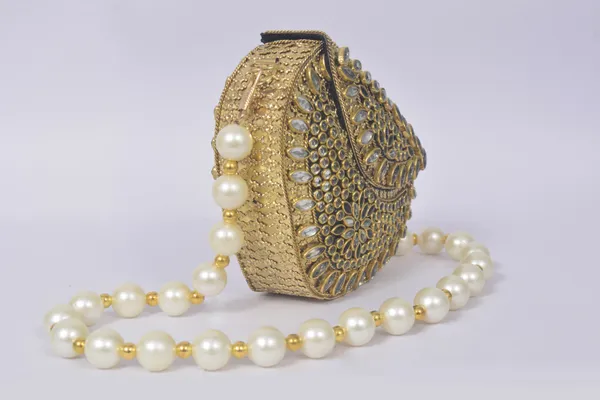 Gold_Mehira_Royal_Kundan_Bag_With_Sparkling_Stones,_Green_Gem,_And_Pearl_Handle