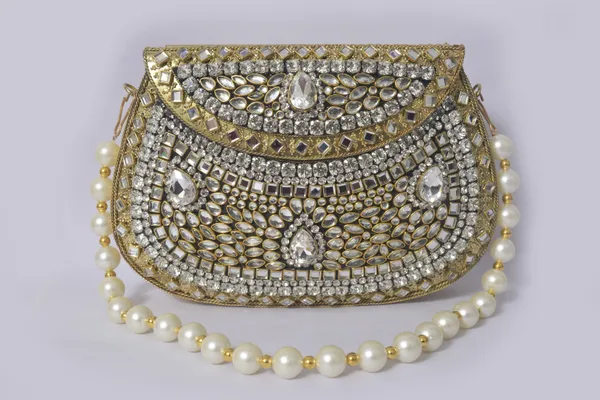 Gold_Antique_Clutch_With_Kundan_Work,_Emerald_Accents,_And_Pearl_Handle