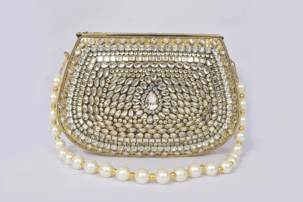 Gold_Antique_Clutch_With_Kundan_Work,_Emerald_Accents,_And_Pearl_Handle