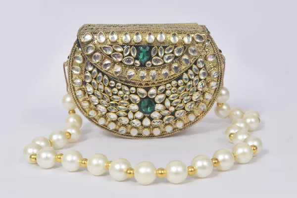 Gold_Kundalya_Pearl_Charm_Clutch_With_Emerald_Stone_Detailing_And_Royal_Gold_Finish