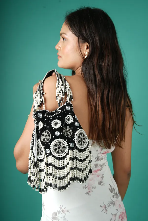 Black_Velvet_Potli_With_White_Pearl_Beading,_Mirror_Accents,_Circular_Embroidery,_And_Cascading_Fringe_Details
