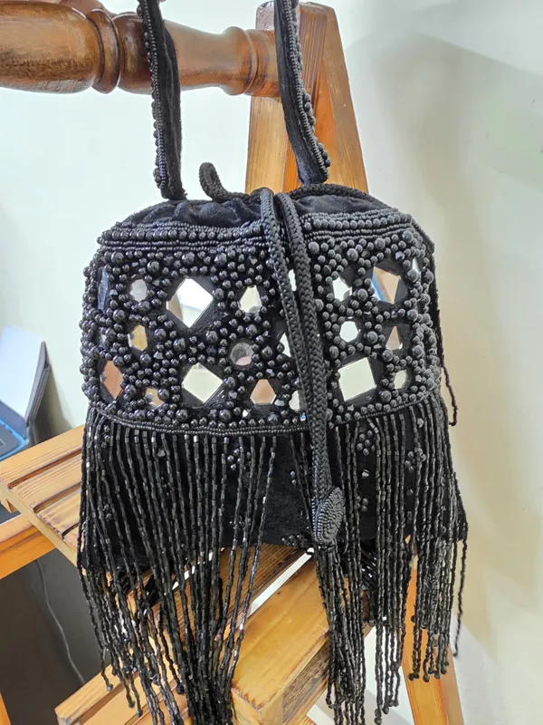 Black_Elegant_Potli_With_Pearls,_Mirrors,_And_Fringe_Detailing