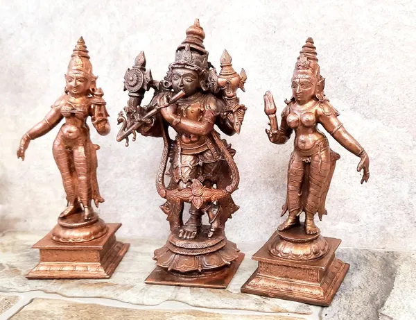 Brownish-Orange_Copper_Idols_Of_God_Venugopala_Swamy_With_Sridevi_And_Bhudevi,_5.7_Inches,_1.5_Kg,_Patina_Antique_Finish,_Pack_Of_3_Piece