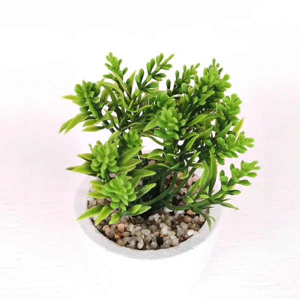 Elegant_Artificial_Green_Plant_Arrangement_in_a_White_Finish_Pot_with_Decorative_Pebbles