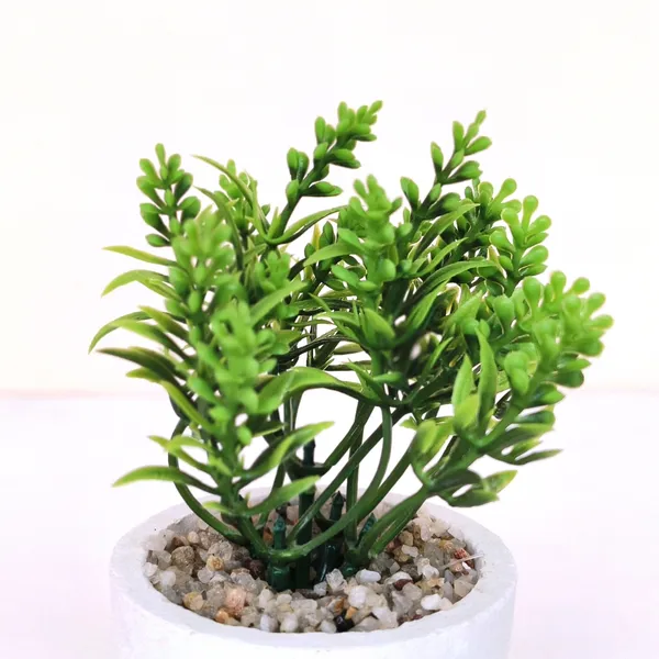 Elegant_Artificial_Green_Plant_Arrangement_in_a_White_Finish_Pot_with_Decorative_Pebbles