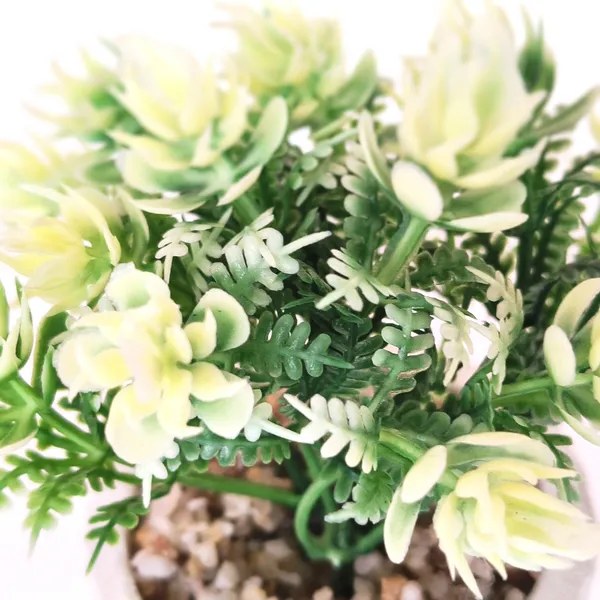 Elegant_Artificial_Green_Plant_Arrangement_in_a_White_Finish_Pot_with_Decorative_Pebbles