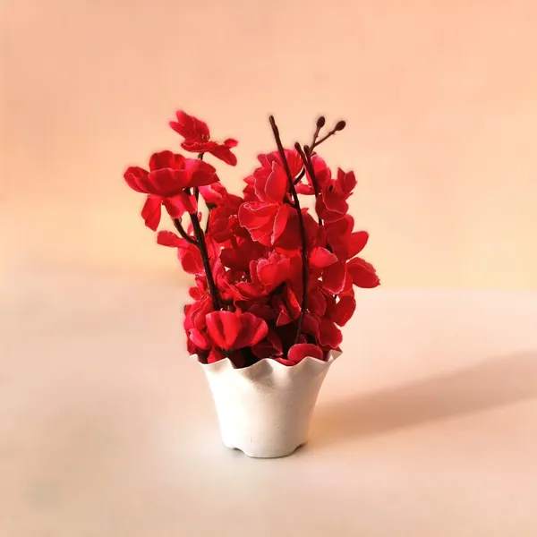Vibrant_Scarlet_Blossom_Arrangement_in_White_Plastic_Vase