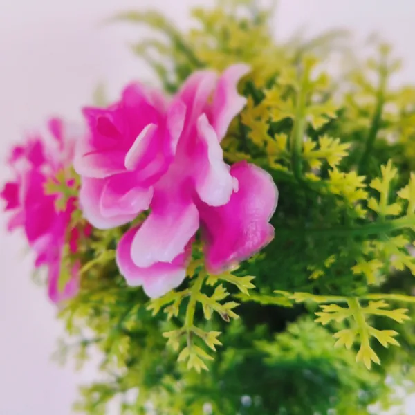 Exquisite_Artificial_Pink_Floral_Arrangement_with_Delicate_White_Accents_in_a_Sleek_White_Plastic_Pot