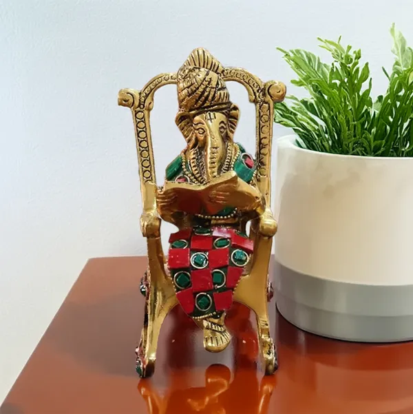 Hastcraft_Metal_Ganesha_Ji_Reading_Book_sitting_on_Chair_with_Handcrafted_Stone_Work_,_Table_Top_Elegant_Decor