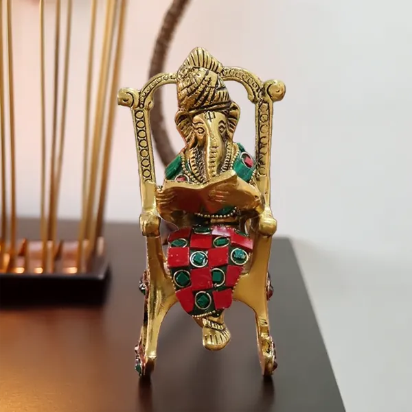Hastcraft_Metal_Ganesha_Ji_Reading_Book_sitting_on_Chair_with_Handcrafted_Stone_Work_,_Table_Top_Elegant_Decor