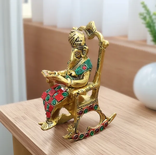Hastcraft_Metal_Ganesha_Ji_Reading_Book_sitting_on_Chair_with_Handcrafted_Stone_Work_,_Table_Top_Elegant_Decor