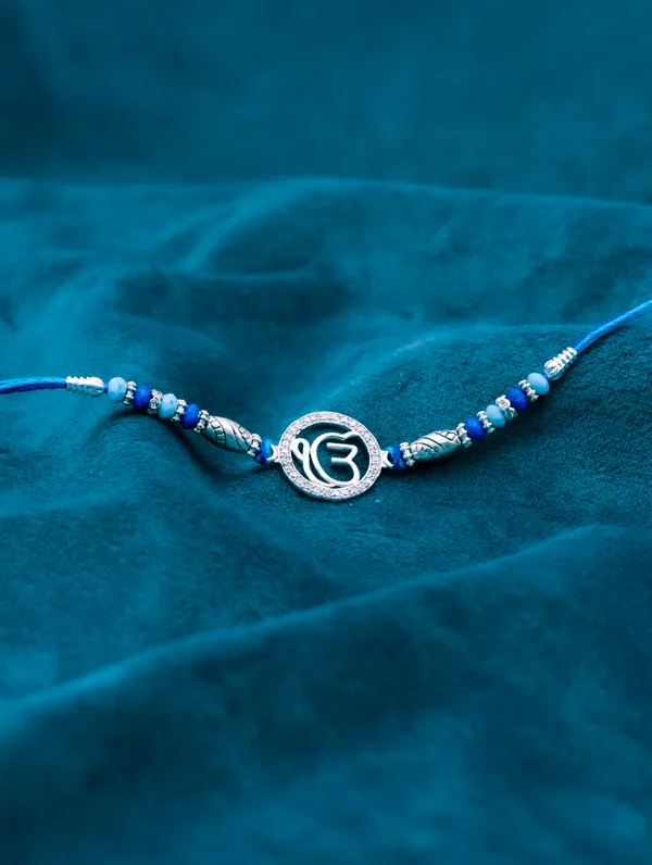 925_Silver_Blue_Rakhi_With_Precious_White_Zircon_Stone_For_Women