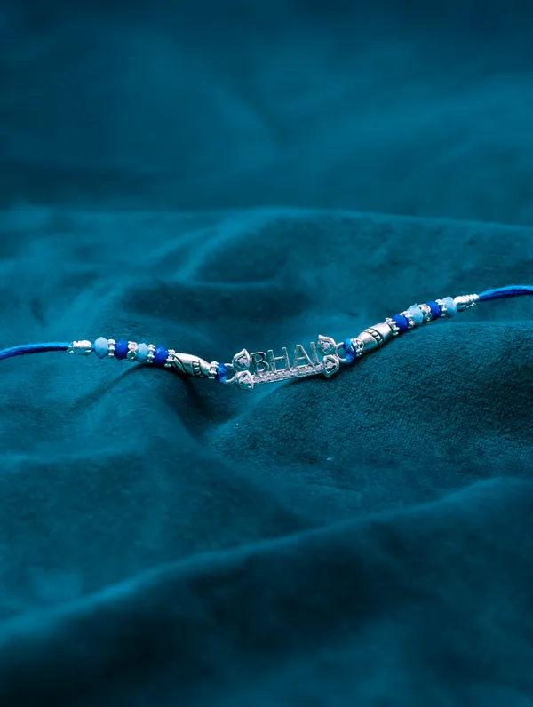 925_Silver_Blue_Rakhi_With_Precious_White_Zircon_Stone_For_Women