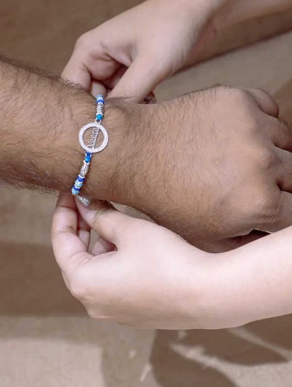 925_Silver_Blue_Rakhi_With_Precious_White_Zircon_Stone_For_Women