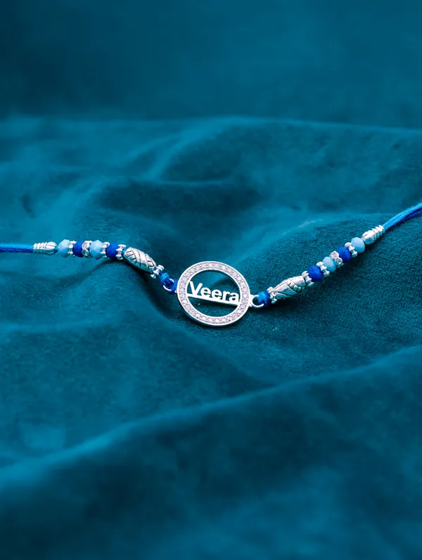 925_Silver_Blue_Rakhi_With_Precious_White_Zircon_Stone_For_Women