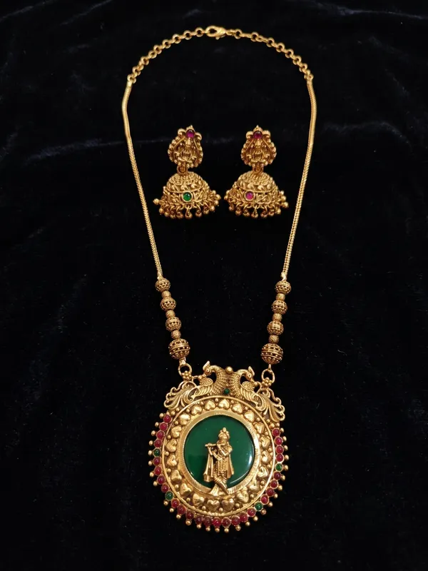 Antique_Gold_Plated_Krishna_Pendant_Chain_Set_with_Laxmi_Jhumka_Earrings_|_Green_Enamel_&_Ruby_Kundan_Jewelry