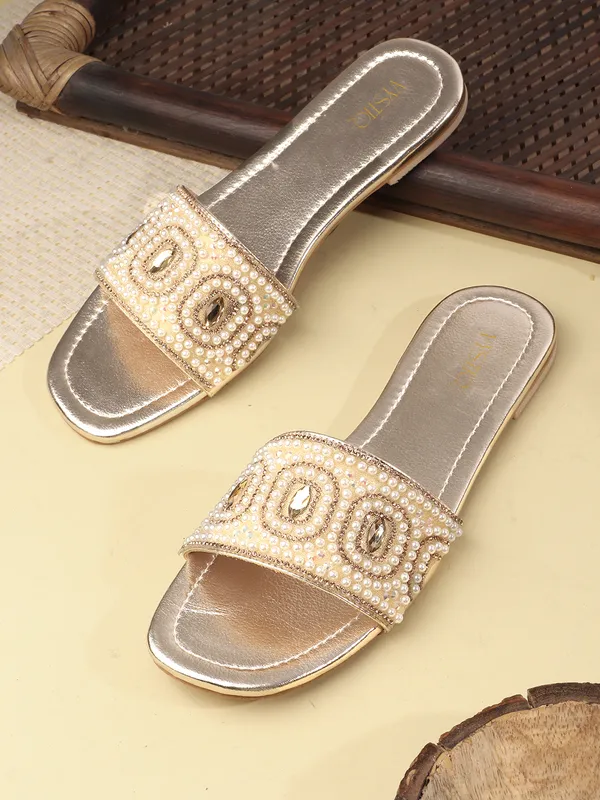 These_flat_slide_sandals_feature_a_metallic_bronze_finish_on_the_footbed_and_sole