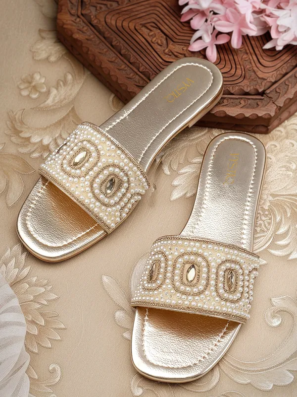 These_flat_slide_sandals_feature_a_metallic_bronze_finish_on_the_footbed_and_sole