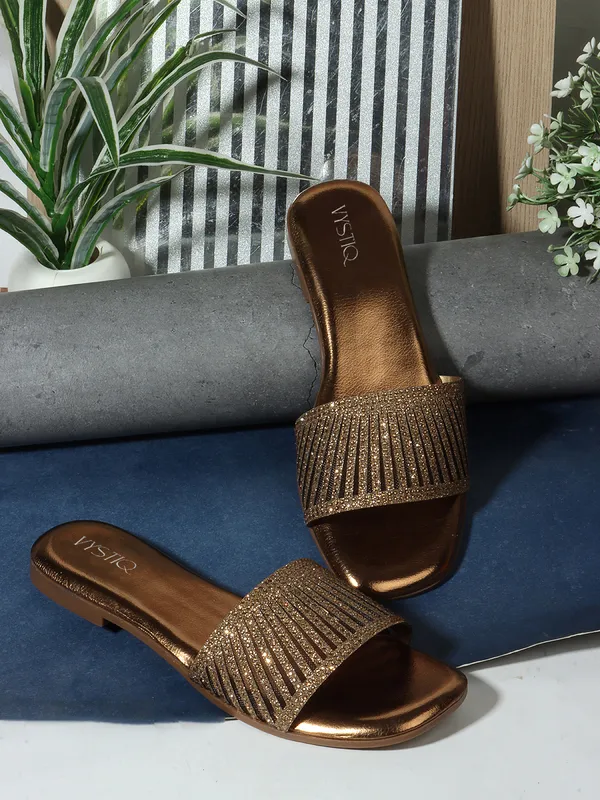 Elegant_slip-on_sandals_with_pearl-studded,_soft_padded_insole,_and_large_decorative_front.