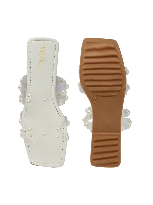 Elegant_slip-on_sandals_with_pearl-studded_,_soft_padded_insole,_and_large_decorative_front.
