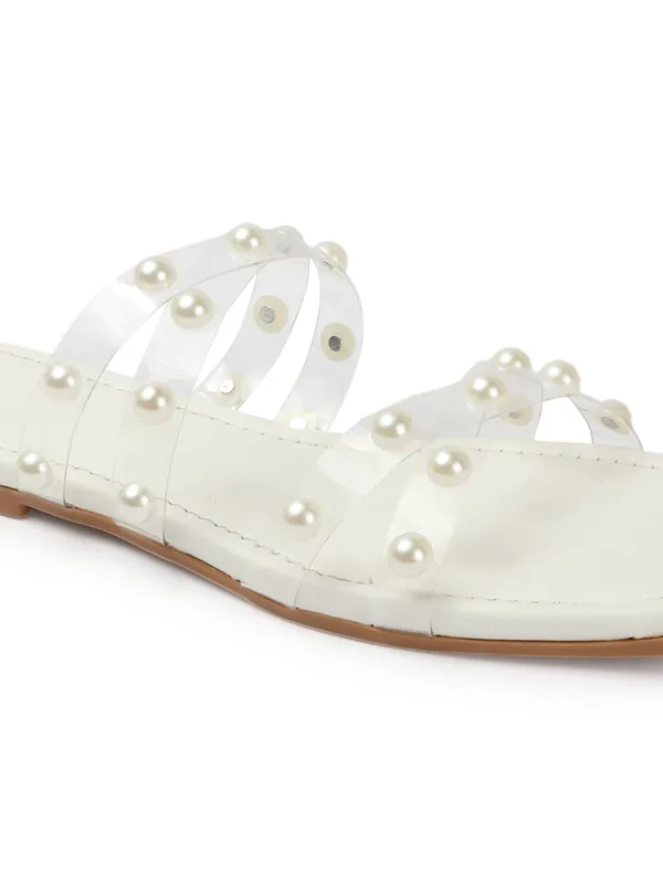 Elegant_slip-on_sandals_with_pearl-studded_,_soft_padded_insole,_and_large_decorative_front.