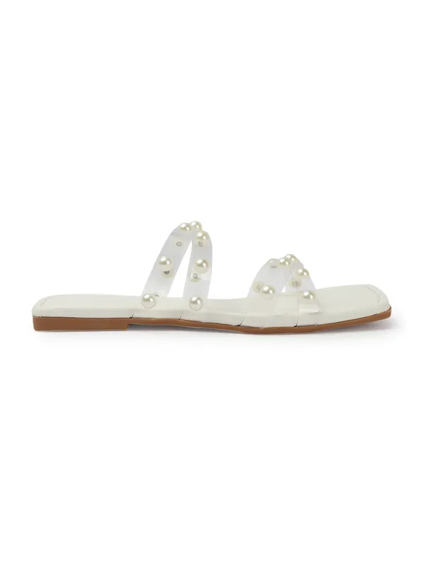 Elegant_slip-on_sandals_with_pearl-studded_,_soft_padded_insole,_and_large_decorative_front.