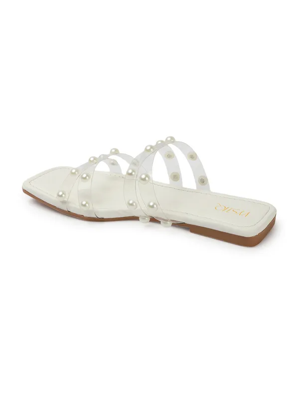 Elegant_slip-on_sandals_with_pearl-studded_,_soft_padded_insole,_and_large_decorative_front.