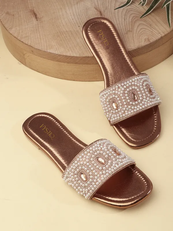 These_flat_slide_sandals_feature_a_metallic_bronze_finish_on_the_footbed_and_sole