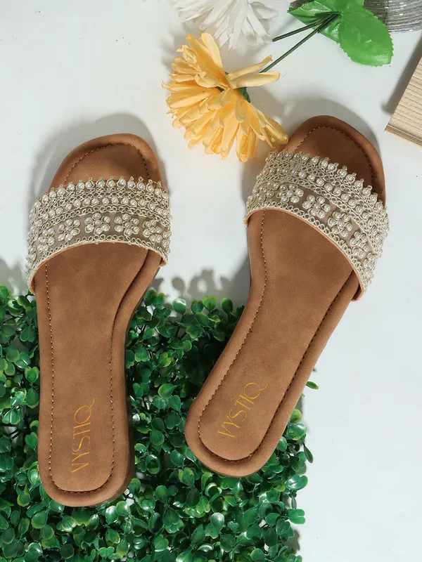 Elegant_slip-on_sandals_with_pearl-studded,_soft_padded_insole,_and_large_decorative_front.Name