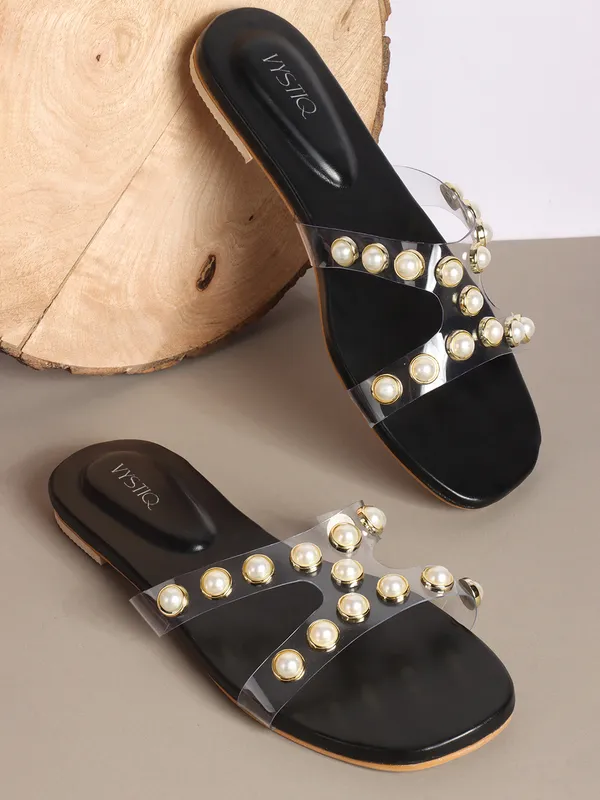 Elegant_slip-on_sandals_with_pearl-studded_V-strap,_soft_padded_insole,_and_large_decorative_front.