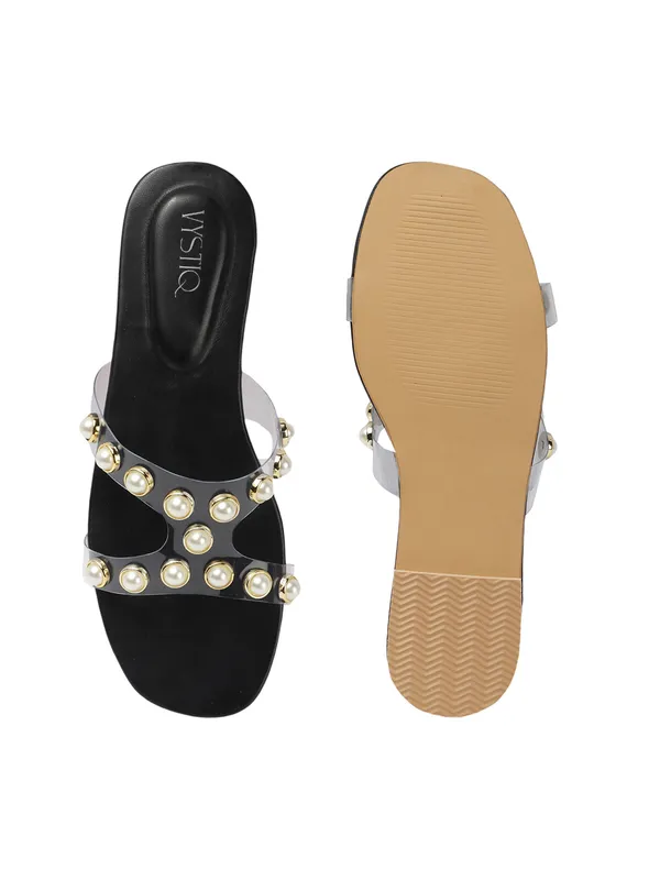 Elegant_slip-on_sandals_with_pearl-studded_V-strap,_soft_padded_insole,_and_large_decorative_front.