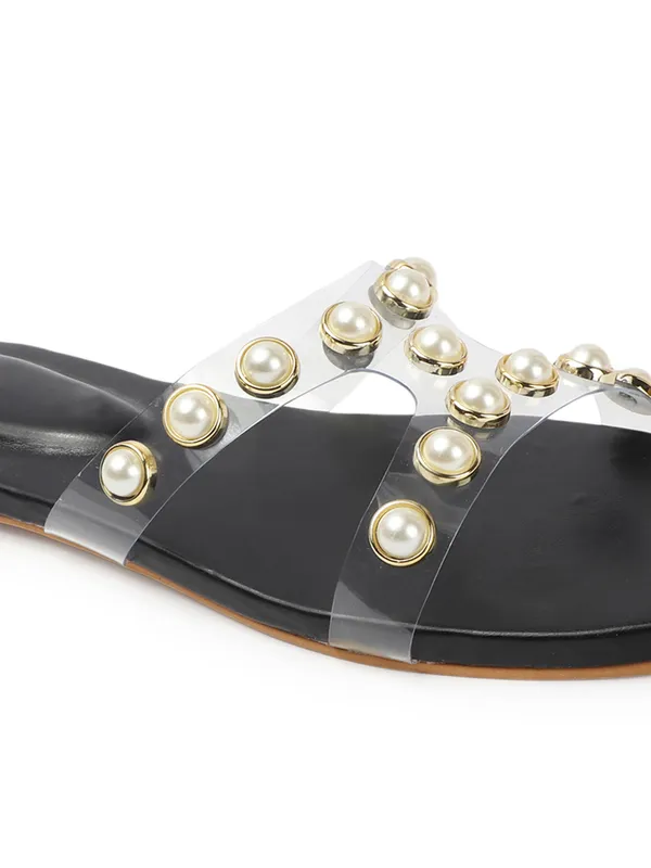 Elegant_slip-on_sandals_with_pearl-studded_V-strap,_soft_padded_insole,_and_large_decorative_front.