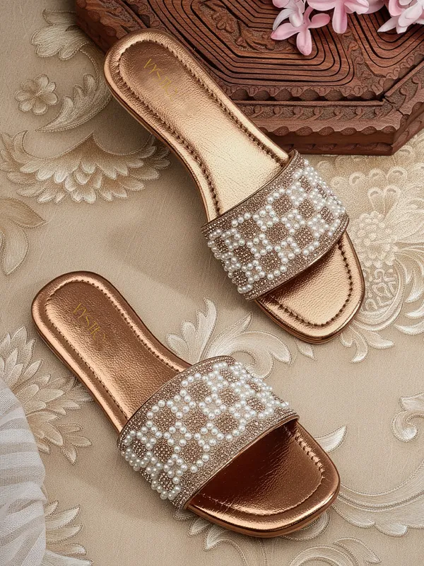 These_flat_slide_sandals_feature_a_metallic_bronze_finish_on_the_footbed_and_sole
