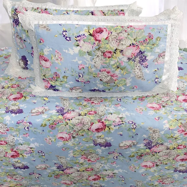 Exquisite_floral_bloom_on_light_blue_on_premium_cotton_bedsheet_and_two_pillow_covers_decorated_with_double_lace