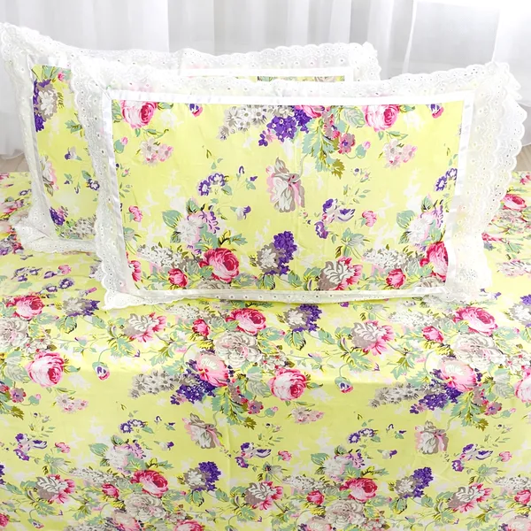 Exquisite_floral_bloom_on_light_yellow_on_premium_cotton_bedsheet_and_two_pillow_covers_decorated_with_double_lace