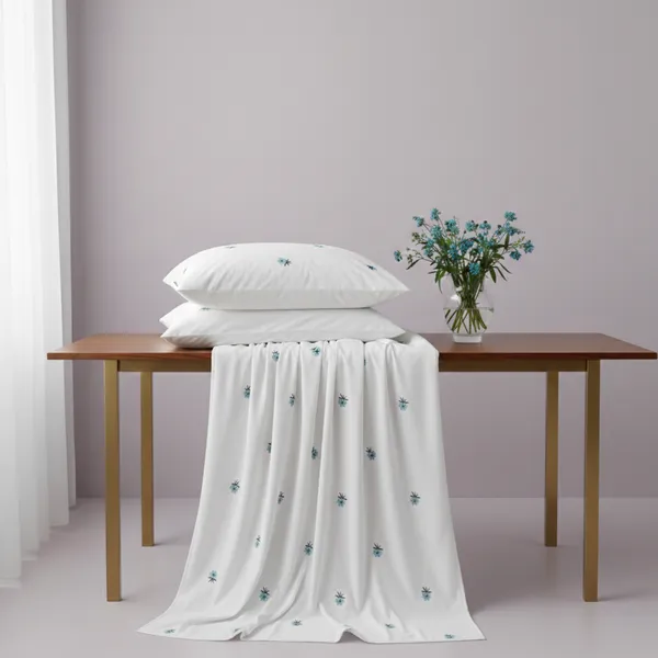 Exquisite_embroidered_bedsheet_with_blue_floral_pattern_on_white_in_premium_cotton_bedsheet_along_with_two_pillow_covers