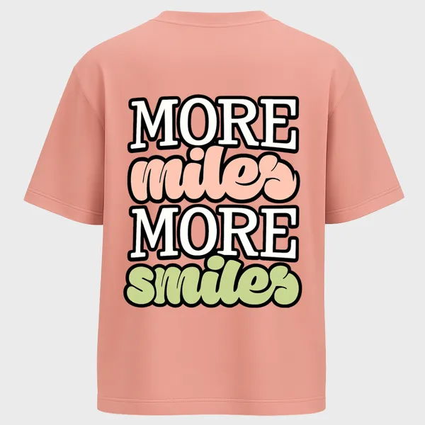_Oversize_Unisex_Pink_Graphics_T-Shirt,_Playful_typography_More_Miles_More_Smiles_with_pastel_pink_and_green_gradient_script_fonts,_motivational_streetwear_vibe._|_GRAPHICS_MODE