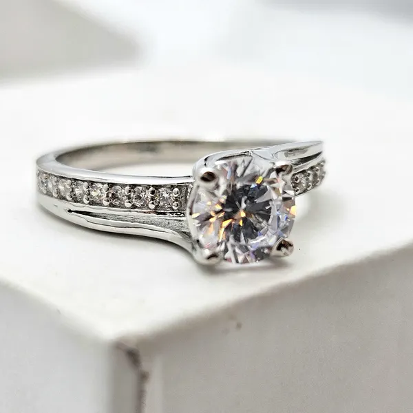 Round-Cut_Solitaire_Engagement_Ring_With_A_Channel-Set_Band