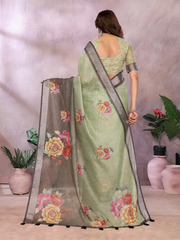 Olive_Green_Olive_Green_And_Black_Saree_Combines_Earthy_Elegance_With_Bold_Floral_Charm._Featuring_Large,_Vibrant_Floral_Prints_In_Shades_Of_Yellow,_Pink,