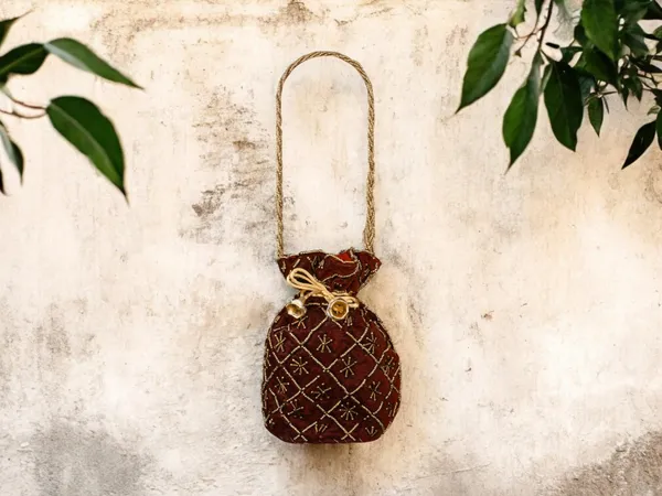 Fuchsia_Embroidered_Potli_Bag_With_Golden_Beadwork_&_Braided_Handle