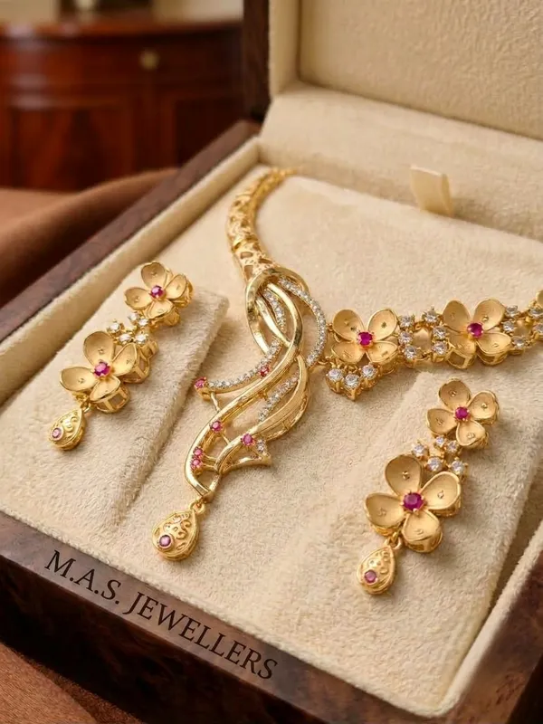 The_Flora_Cascade_Asymmetric_Collar_Necklace_&_Dangler_Earrings_in_Matte_Gold_with_Ruby_Blossoms_and_Micro-Pave_AD_|_MAS_JEWELLERS
