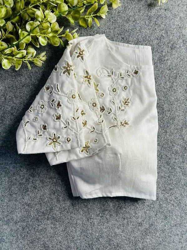 Premium_white_blouse_with_intricate_hand_embroidery_and_bead_detailing.