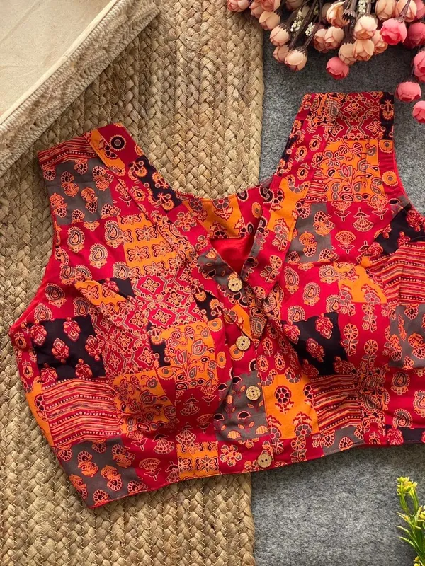 This_is_a_pure_Ajrakh_cotton,_handloom,_boat_neck_blouse_with_a_front_hook_closure_and_a_multicolor_patchwork_print.
