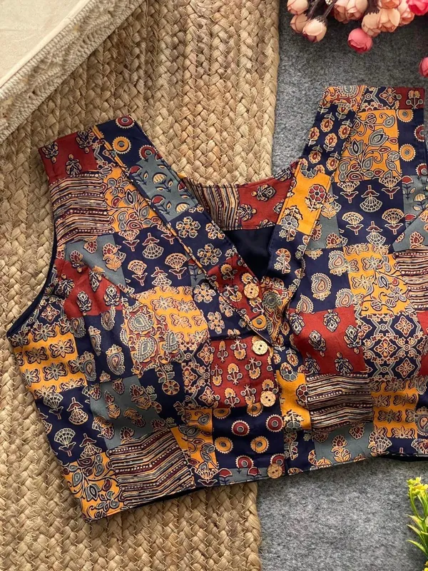 This_is_a_pure_Ajrakh_cotton,_handloom,_boat_neck_blouse_with_a_front_hook_closure_and_a_multicolor_patchwork_print.