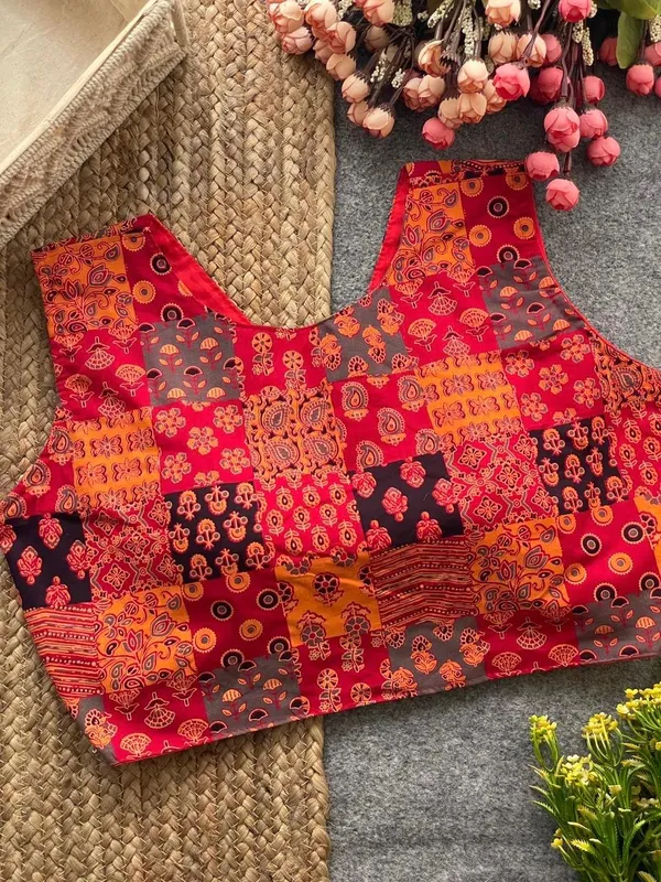 This_is_a_pure_Ajrakh_cotton,_handloom,_boat_neck_blouse_with_a_front_hook_closure_and_a_multicolor_patchwork_print.