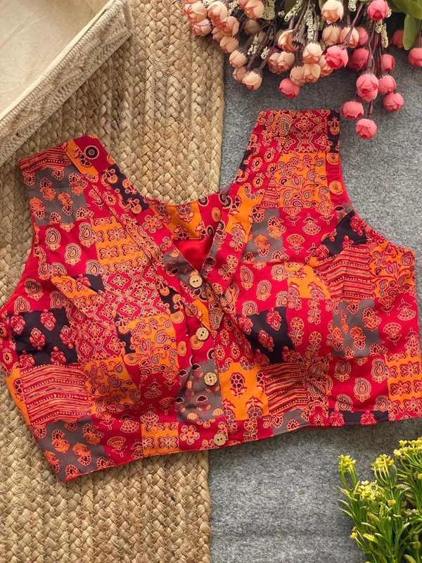 This_is_a_pure_Ajrakh_cotton,_handloom,_boat_neck_blouse_with_a_front_hook_closure_and_a_multicolor_patchwork_print.